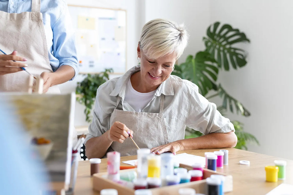 A 60 something woman, painting.